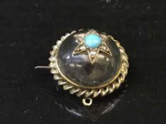 A yellow metal and rock crystal brooch set with diamonds and turquoise