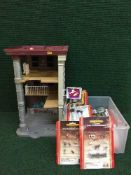 A Ghost buster's fire house, together with a box of Hornby accessories including signals,