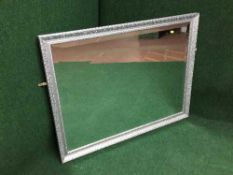 A silvered framed over mantel mirror