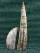 Two carved resin tusks