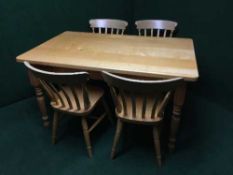 A pine beech topped kitchen table together with four chairs
