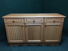 A contemporary oak effect triple door sideboard