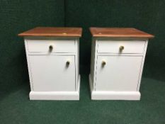A pair of painted teak topped bedside cabinets