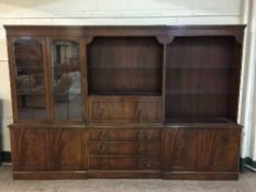 A mahogany Regency style triple section bookcase fitted a bureau