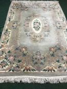 A green fringed embossed Chinese carpet