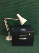 A Sentry fire safe with keys together with an angle poise lamp