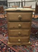 A narrow pine four drawer chest