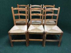 A set of six pine rush seated ladder backed chairs
