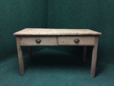 A reclaimed pine kitchen table fitted with two drawers