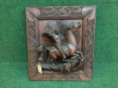 A heavily carved Eastern wall panel depicting a hunter on horse back killing a buffalo