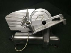A stainless steel commercial meat slicer