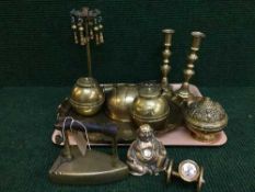 A tray of assorted brass ware - flat irons, candlesticks,