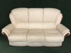 A cream leather three piece suite