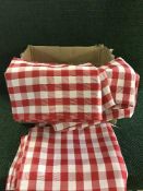 A box of red and white checkered table covers