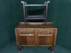 A carved oak sideboard and a serving trolley