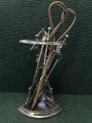 An early 20th century chrome corer stick stand with carpet beater and companion set