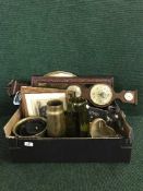 A box of barometer, framed pictures, shell casing,