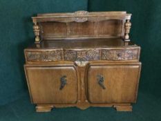 A carved oak buffet backed sideboard