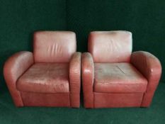 A pair of red leather club chairs