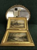 An oval framed mirror and two gilt framed oils on panels
