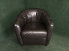 A brown faux leather tub chair