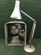 A cased projector and screen, box of slides, cameras, angle lamp etc.