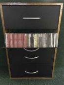 A contemporary four door cd rack containing a large quantity of classical cds