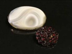 A gold and agate brooch and a gold and garnet set brooch