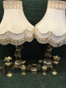 A pair of brass and marble cherub table lamps, brass dragon handled pot,
