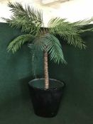 A large artificial palm tree in pot