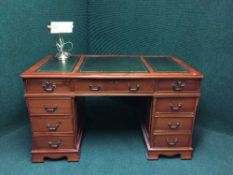 A yewwood twin pedestal desk with tooled leather top,