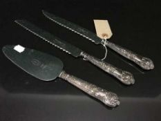 A three piece silver handled cake slice and knife set