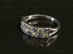 An 18ct gold sapphire and diamond half-eternity ring