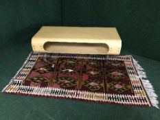 An Ikea storage coffee table and a fringed woolen rug