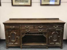 A late Victorian carved oak sideboard