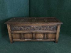An early 20th century carved oak blanket box