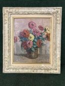 A cream and gilt oil on canvas - still life indistinctly signed