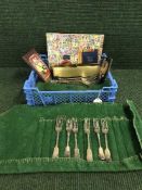 A crate of cutlery, badge on plaque, stamp album,