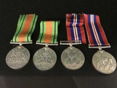 Four unnamed WWII medals with suspension ribbons