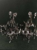 A metal six way light fitting together with two metal lights with glass drops