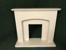 A contemporary cream marble fire hearth