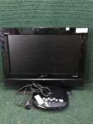 A Sanyo 26 inch LCD tv with remote together with a pine two-tier stand,