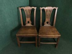 A pair of 19th century elm dining chairs