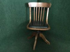 An Edwardian oak swivel desk chair