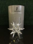 Two boxed Swarvoski ornaments - prism paperweight and a star