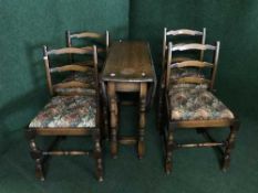 A narrow oak gate leg table and four chairs