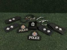 A tin of hand cuffs, police badges,