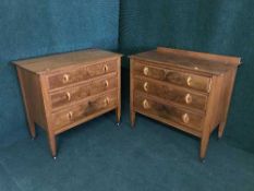 A pair of walnut three drawer chests
