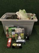 A plastic tub of golfing accessories including balls, tees, dvds, ball markers etc.