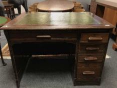 A 1930's oak clerk's desk with tooled leather top